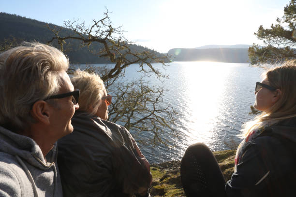 istock Hikers relax by lakeside at sunset 1141619786
