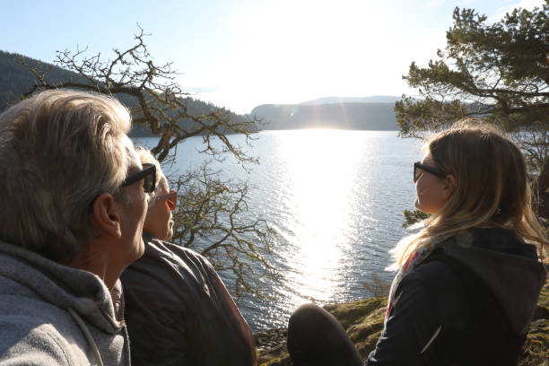 istock Hikers relax by lakeside at sunset 1141619822