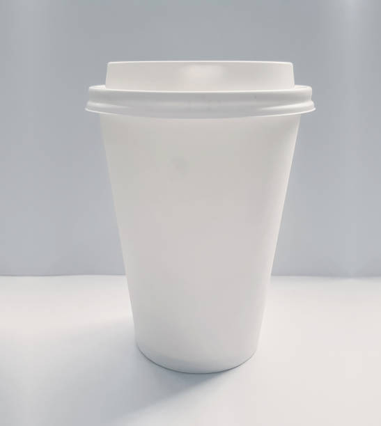 istock Blank white disposable paper coffee cup isolated on a gray background 1141621411