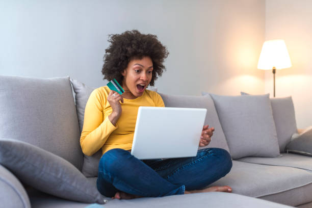 istock Woman is holding credit card and using laptop computer. 1141621476