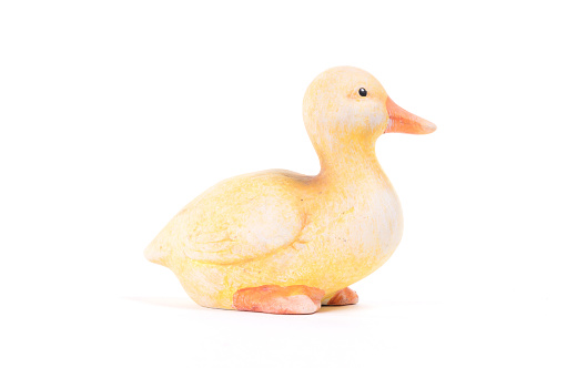 Small yellow statue of a duckling, isolated on white