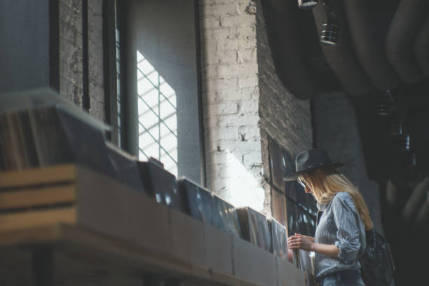 Young woman browsing records in the store