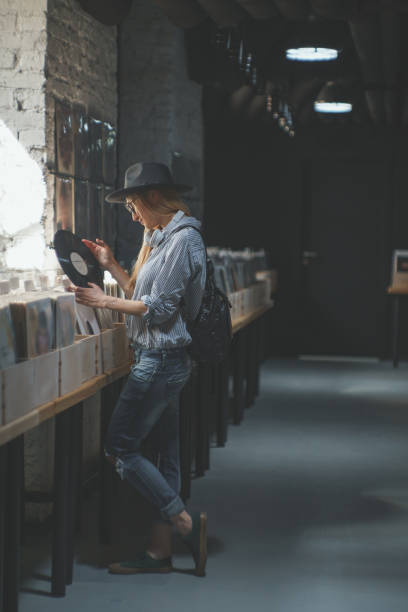 istock Attractive girl with a record indoors 1141621832