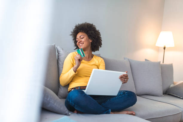 istock Woman is holding credit card and using laptop computer. 1141622526