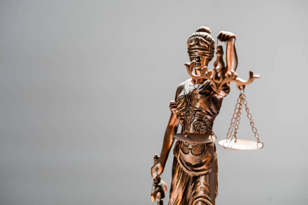istock Statue of blind goddess Themis on blurred background 1141623301