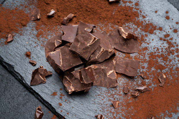 istock Dark or milk organic chocolate pieces on dark concrete backgound 1141624918