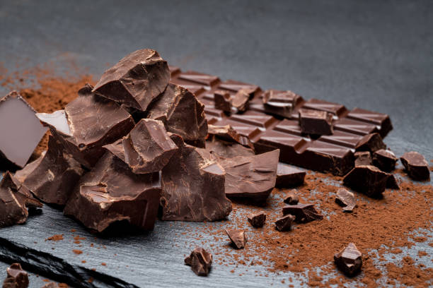 istock Dark or milk organic chocolate pieces on dark concrete backgound 1141624923
