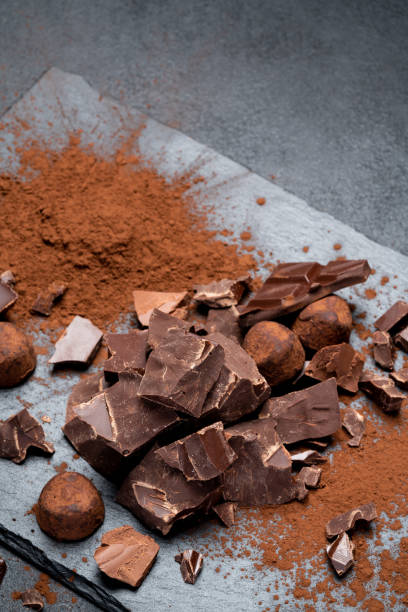 istock Dark or milk organic chocolate pieces on dark concrete backgound 1141624940