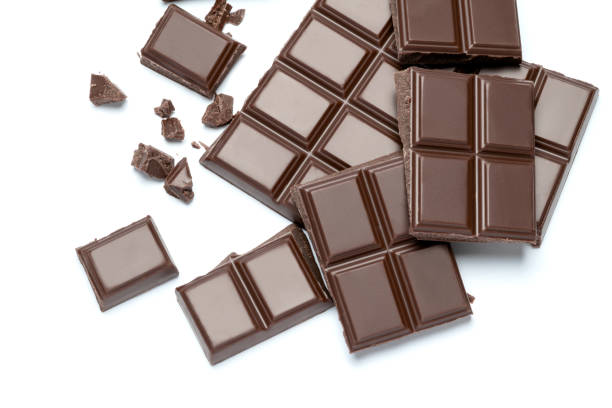 istock Dark organic chocolate pieces isolated on white background 1141625036