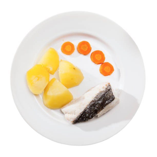 istock Codfish prepared on steam  with potatoes and carrots at plate 1141625562
