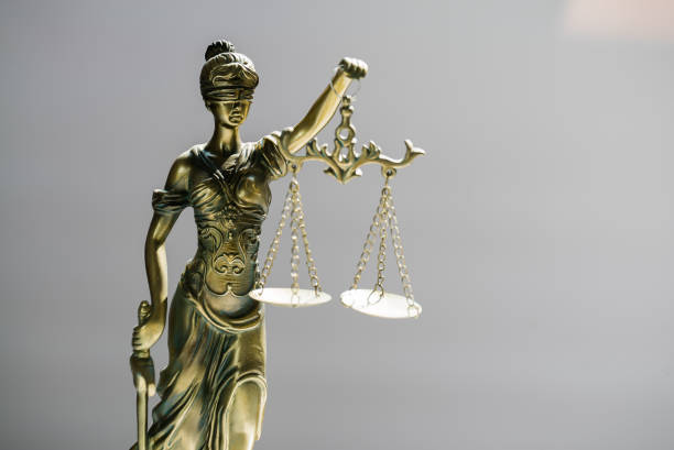 istock Statue of blind goddess Themis on blurred background 1141625819