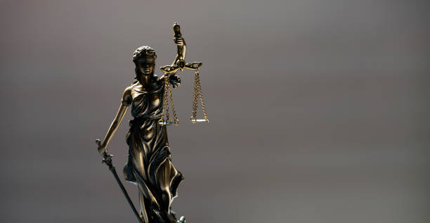 istock Statue of blind goddess Themis on blurred background 1141627249