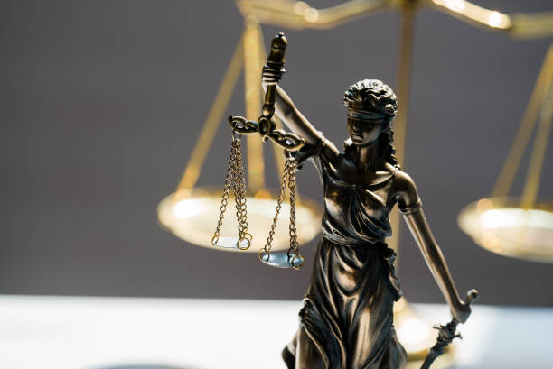 istock Statue of blind goddess Themis on blurred background 1141628569