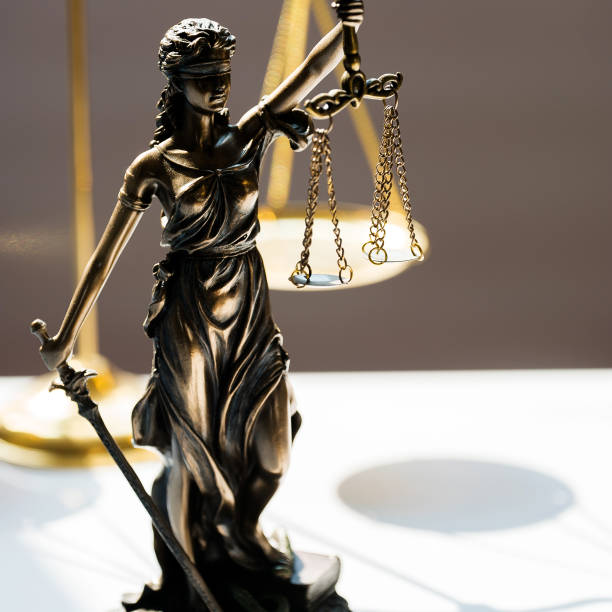istock Statue of blind goddess Themis on blurred background 1141629140