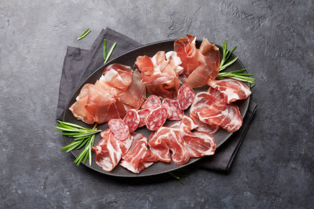 istock Spanish jamon, prosciutto crudo ham, italian salami 1141629174