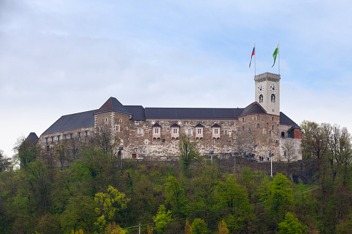 Ljubljana, Slovenia - April 09 2019: Ljubljana Castle is a castle complex standing on Castle Hill above downtown Ljubljana. It is a key landmark of the town. Originally a medieval fortress, it was probably constructed in the 11th century and rebuilt in the 12th century.