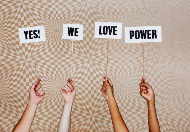 istock Raised hands hold signs 