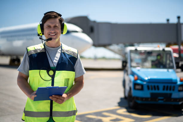 istock Cheerful man in headphones with microphone holding clipboard 1141641148