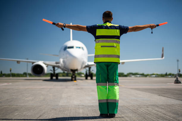 istock Aviation marshall directing airplane parking 1141641176