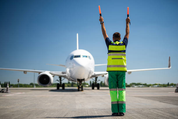 istock Aviation marshall raising hands and signaling 1141641181