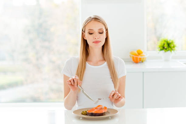 Portrait of cute charming lady dieting have lunch peas protein vegetable use snacking fork knife break pause sit big kitchen wear modern cotton clothing.