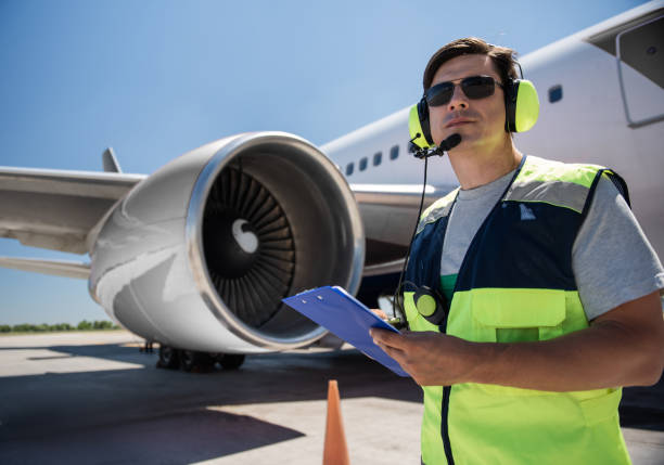 istock Airport worker with clipboard near giant jet engine 1141642751