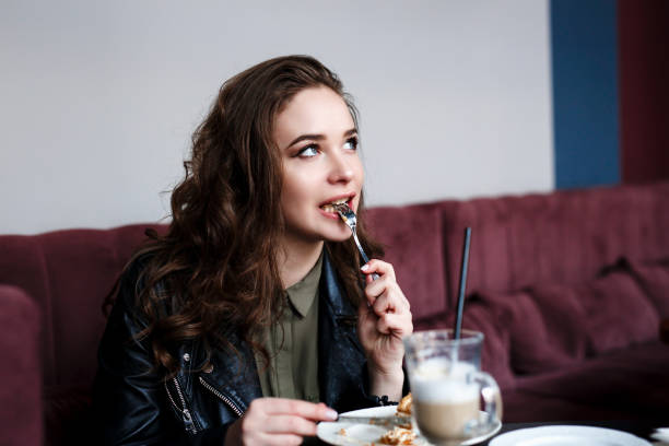 istock Woman in a restaurant enjoying her cake 1141644762