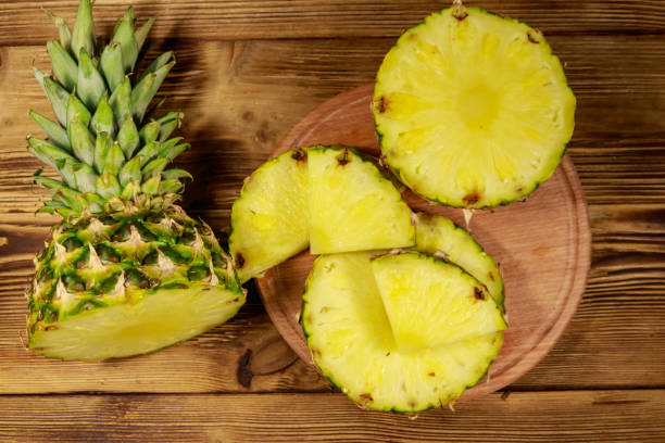 istock Fresh pineapple on wooden table. Top view 1141644946