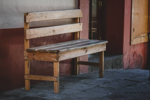 istock An old wooden bench on a paved street. 1141646554
