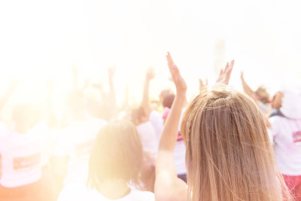 istock Cheering woman and crowd at a concert 1141648604