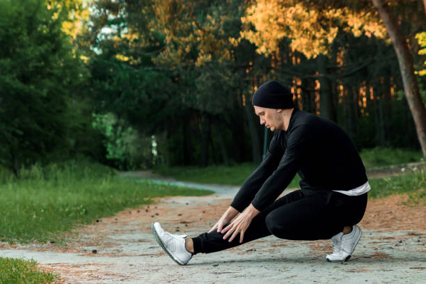 istock A man is doing exercises preparing for morning workout in a green park on a summer morning 1141649253