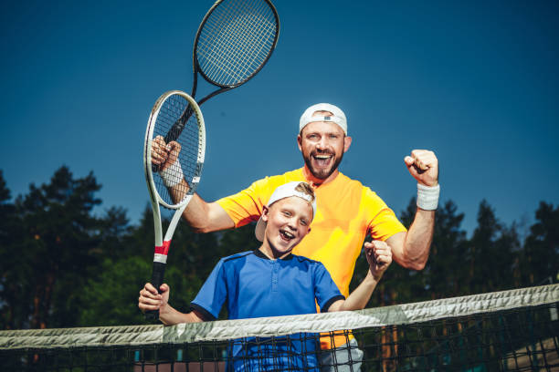 istock Satisfied man and boy playing tennis 1141650700