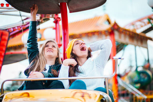 istock Two friends at amusement park 1141655118