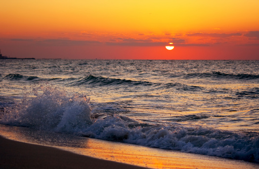 Beautiful Sunset on Beach, big waves of the sea while sunset in sharjah - uae