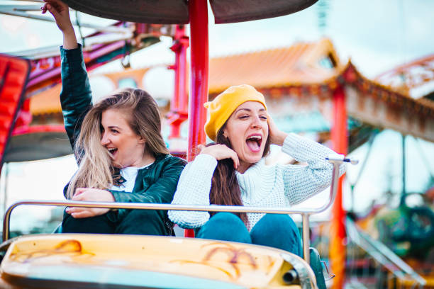istock Two friends at amusement park 1141656091
