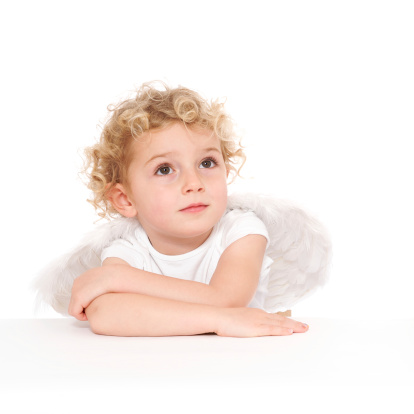 A child wearing angel wings and looking upwards.