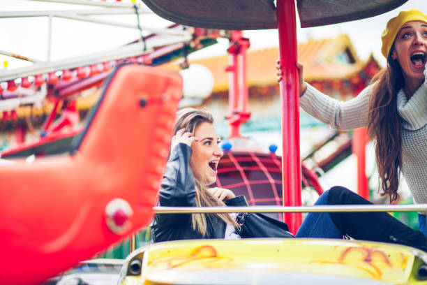 istock Two friends at amusement park 1141658247