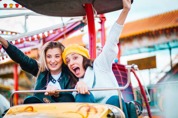 istock Two friends at amusement park 1141658686