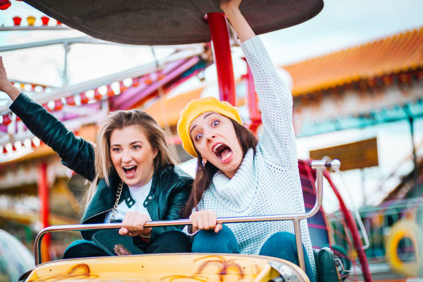 istock Two friends at amusement park 1141660459