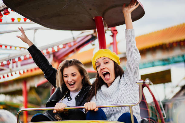 istock Two friends at amusement park 1141660815