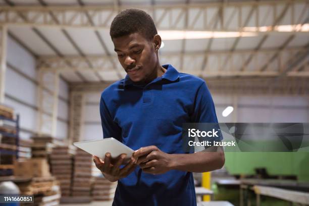 Worker Using Digital Tablet In Industry Stock Photo - Download Image Now - 25-29 Years, Adult, Adults Only