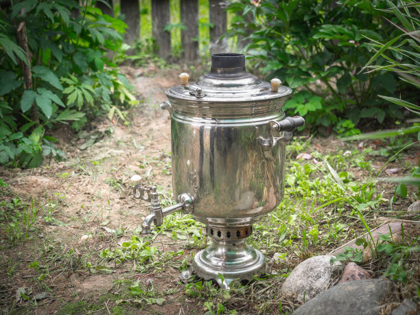 istock Smoking russian samovar standing on the ground in sunny summer garden 1141662105