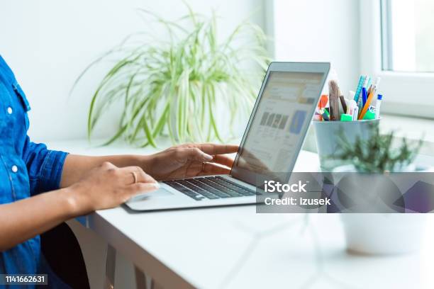 Midsection Of Pregnant Businesswoman Using Laptop Stock Photo - Download Image Now - Plant, Desk, Device Screen