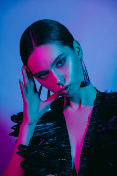 istock High Fashion model in colorful bright neon lights posing at studio 1141663780