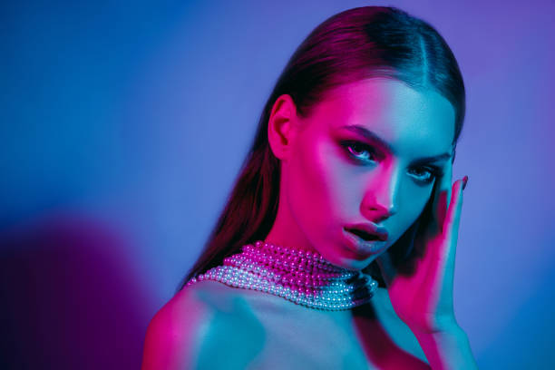 istock High Fashion model in colorful bright neon lights posing at studio 1141663794