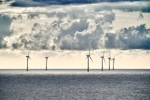 Wind turbines stand in the north sea, generate climate-neutral electricity for Europe.