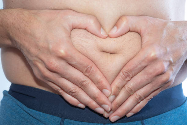 istock Hands as a heart over a fat belly 1141663978