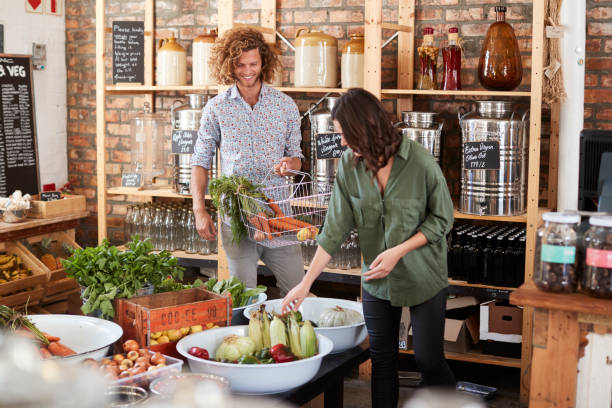 istock Couple Buying Fresh Fruit And Vegetables In Sustainable Plastic Free Grocery Store 1141664607
