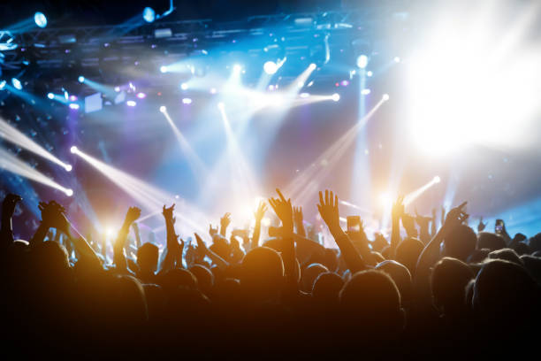 istock Performace of a popular group. Crowd is dancing and having fun. Bright spotlig 1141666281