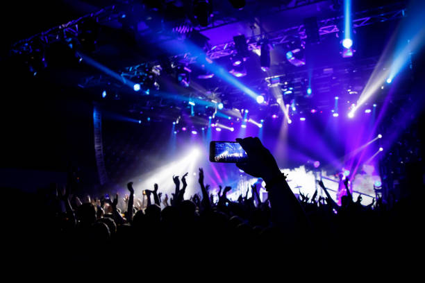 istock Filming a concert on mobile phone camera, 1141666301
